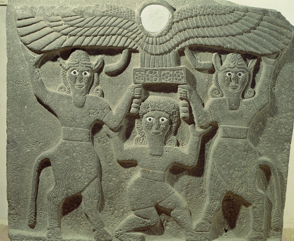 Relief depicting Gilgamesh between two bull-men supporting a winged sun ...