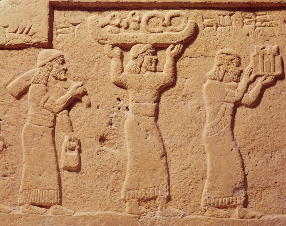 Relief depicting porters laden with gifts by Assyrian