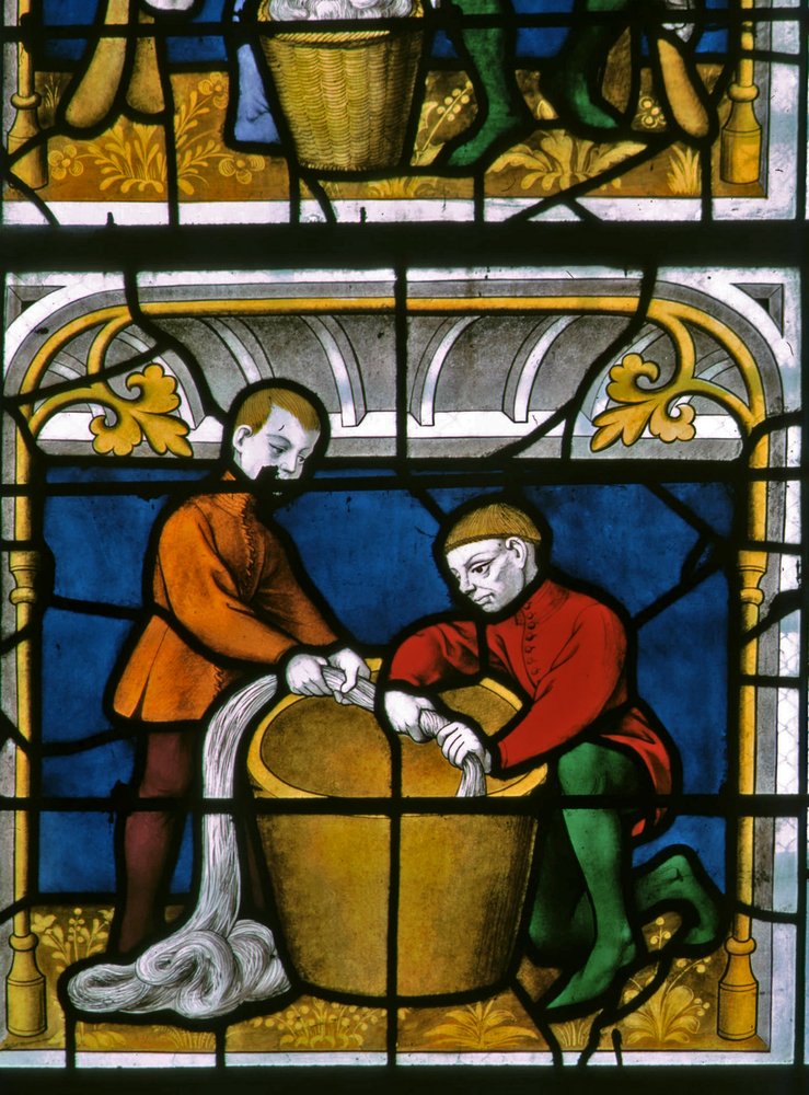 Window w25 depicting a draper at work in the Drapers window
