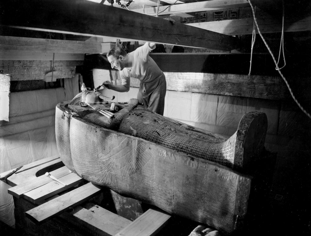 Discovery of the tomb of Pharaoh Tutankhamun in the Valley of the Kings (Egypt): in the burial chamber, Howard Carter working on the lid of the second coffin, October 1925, photo by Harry Burton (p1568) by Harry Burton
