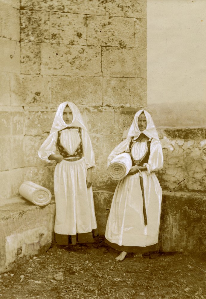 Two women wearing traditional costumes, orbace sellers, Sardinia, Italy ...