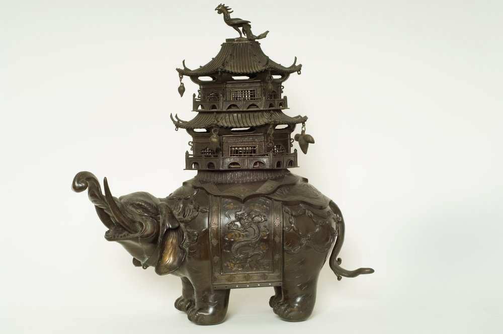 Figure of an elephant wearing a howdah cloth, elaborate surcingle and a ...
