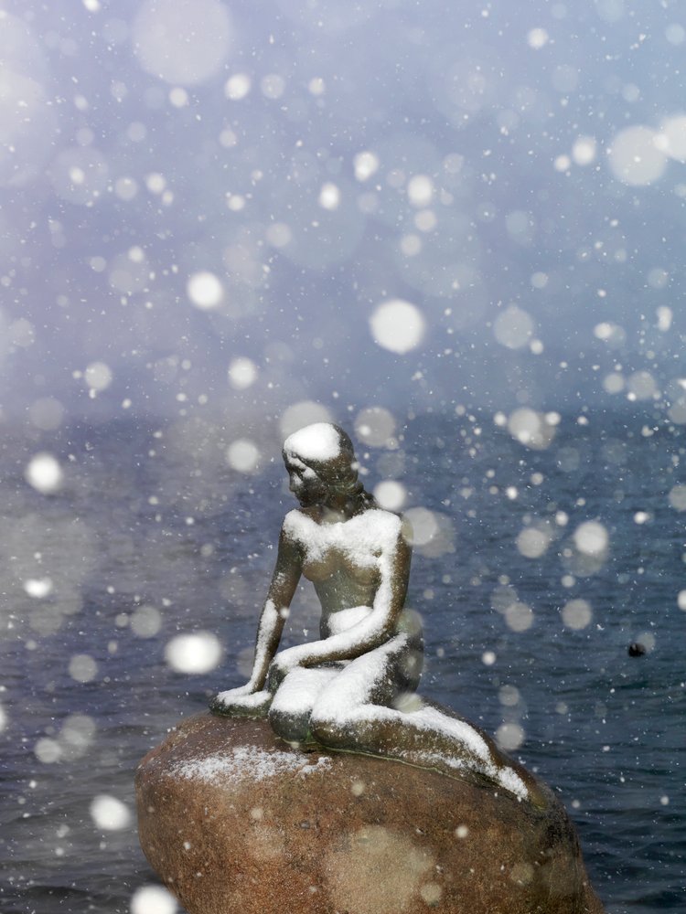 Snow storm on The Little Mermaid statue by Edvard Eriksen, winter in Copenhagen Denmark, 2022 by Sisse Brimberg