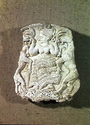 Lid of a pyxis depicting the Mistress of the Animals feeding two wild goats