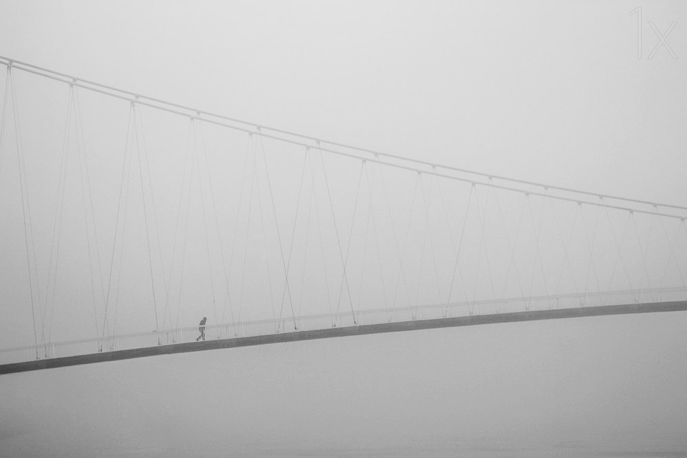 Solitary Walk on Foggy Bridge by Krunoslav Nevistic