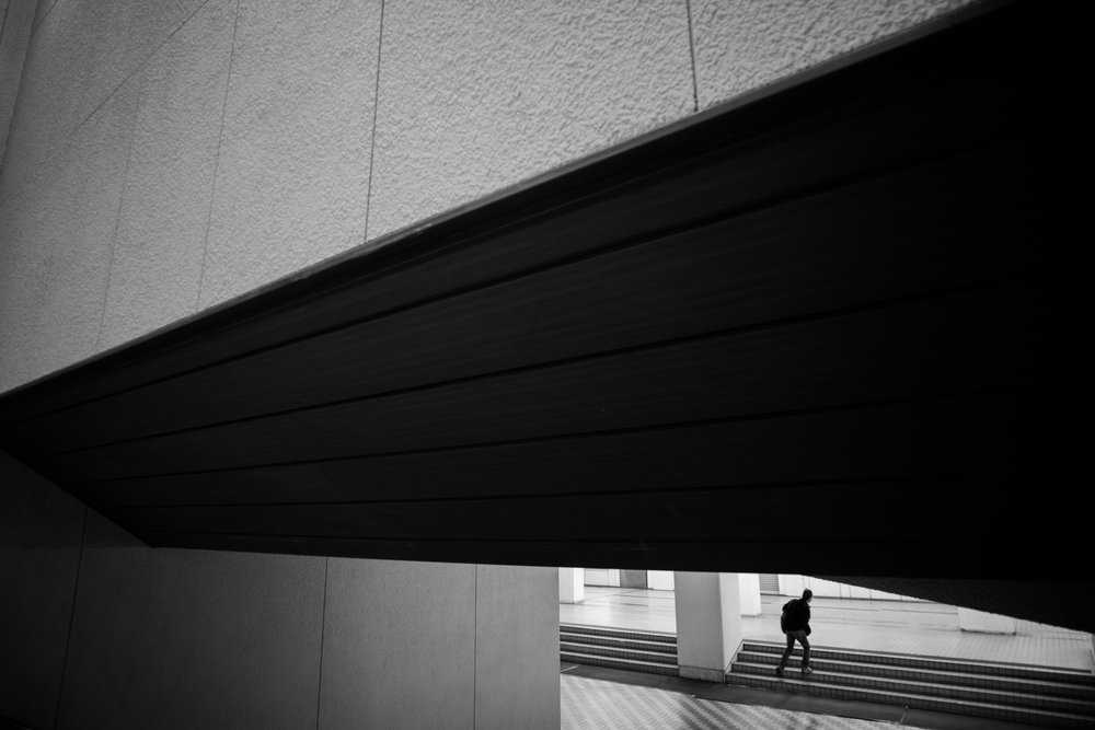 Solitary Figure Ascending Stairs by Satoshi Hata