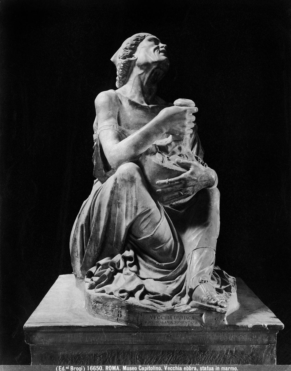 Statue of an old drunken woman holding a wineskin by (after) Myron