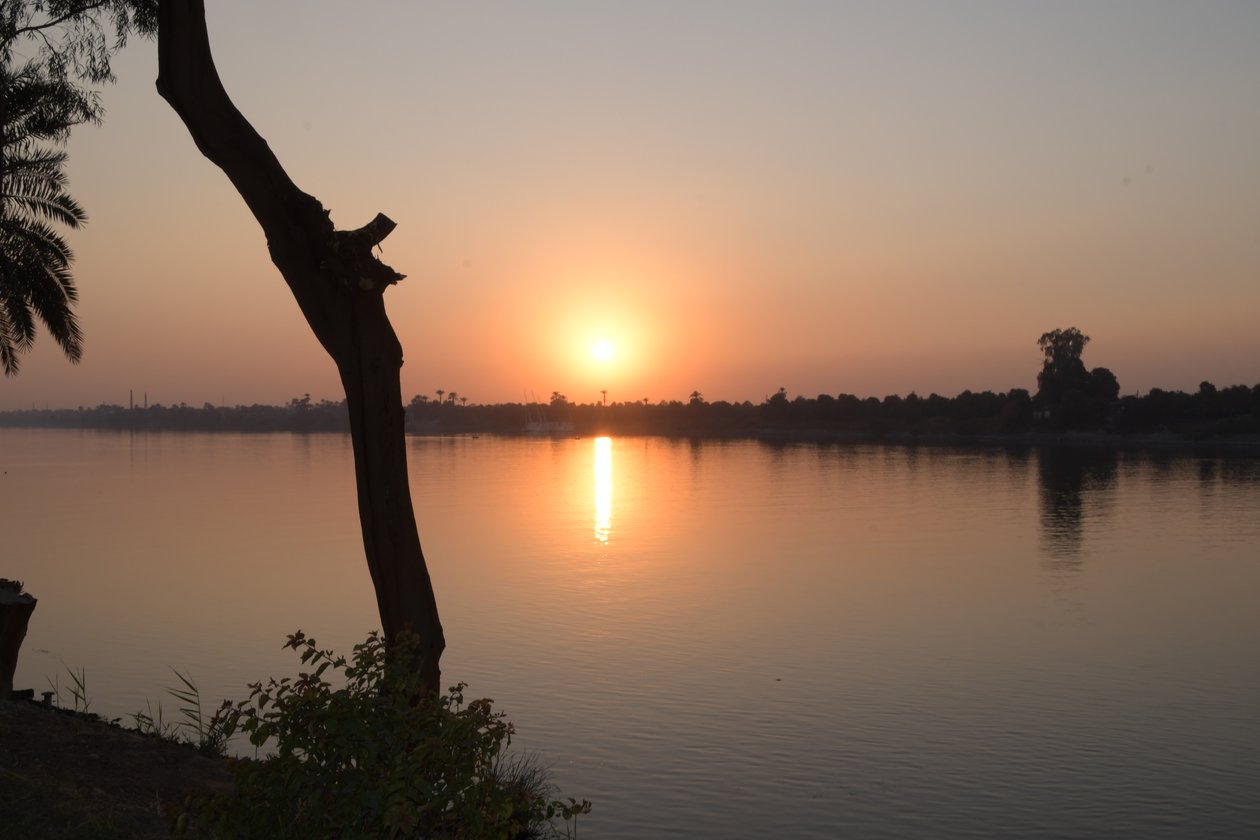 Golden Sunset Reflections on a Tranquil River by Albert Mansour