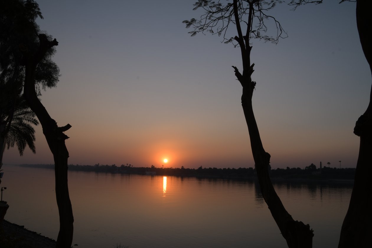 Golden Sunset Reflections on a Tranquil River by Albert Mansour