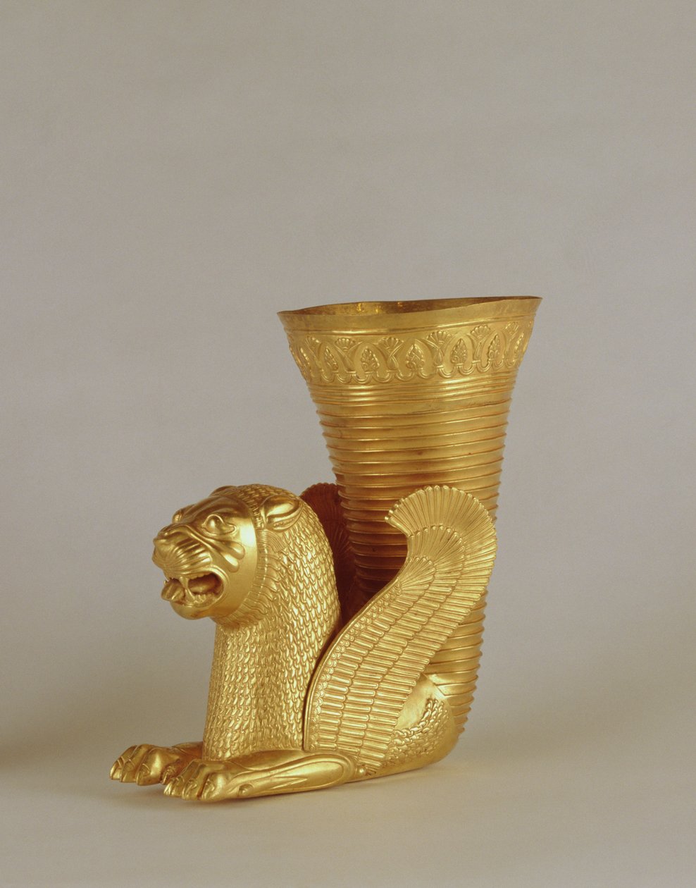 Rhyton in the shape of a seated lion-monster, from Hamadan, Iran (gold) by Achaemenid