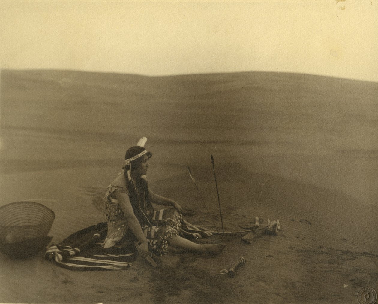 A seated Native American woman by American Photographer