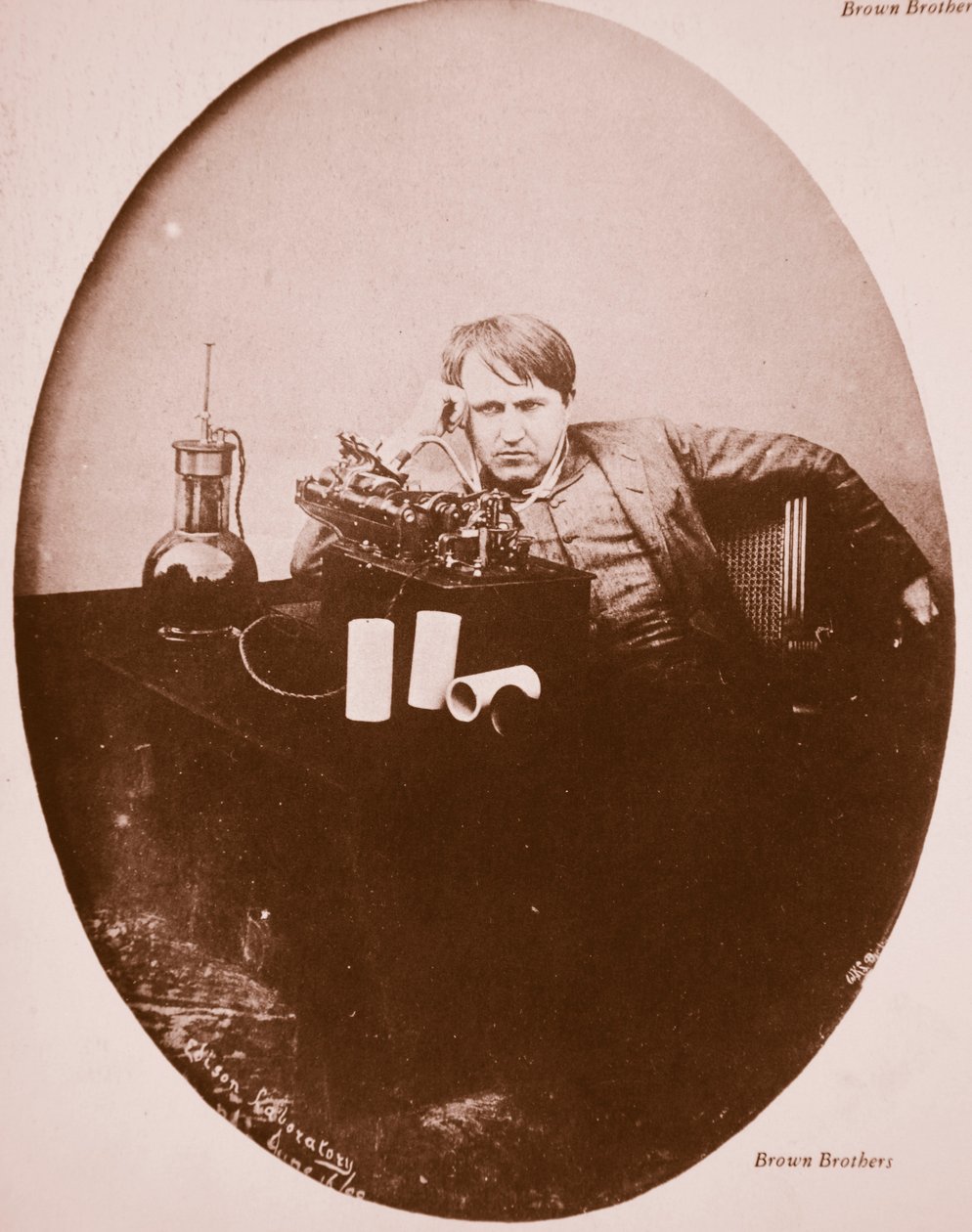 Thomas A. Edison sitting by his improved machine, 1889 by American Photographer