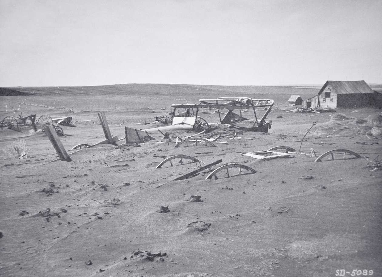 Car and farm machinery buried by dust and sand, Dallas, South Dakota by American Photographer