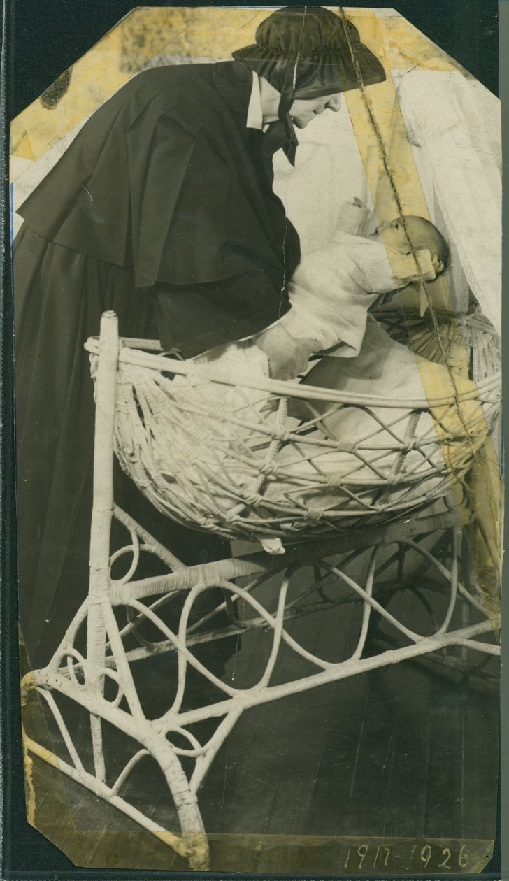 New York Foundling Hospital - Sister Anna Michella with baby and cradle by American Photographer