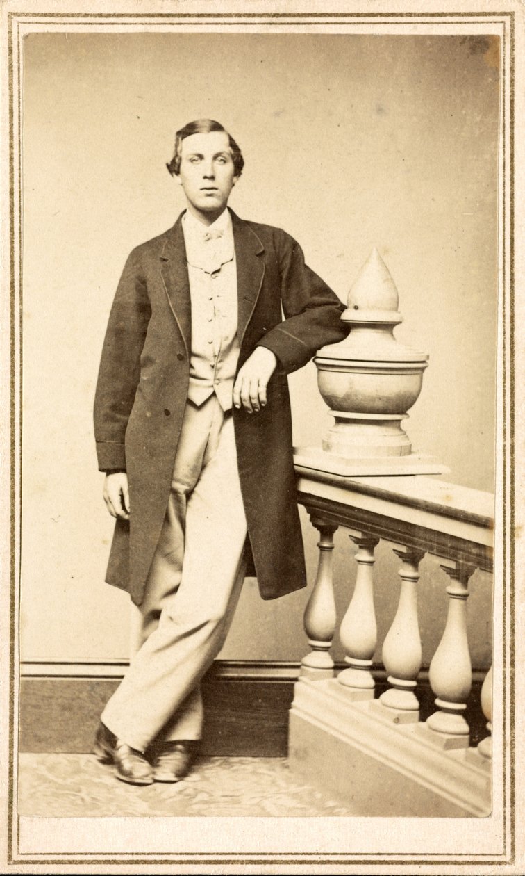 Unidentified man in top coat leaning against pillar, c.1860-75 by American Photographer