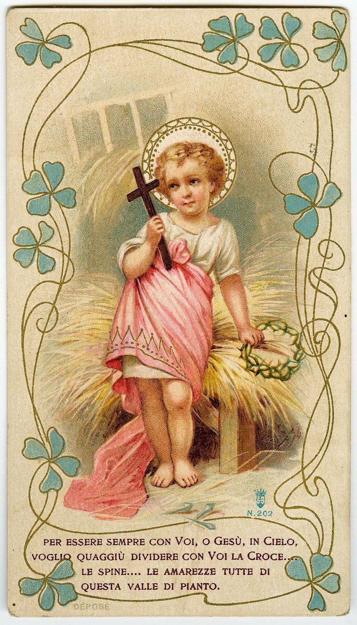 A little boy holding the cross and the crown of thorns, in order to share Jesus