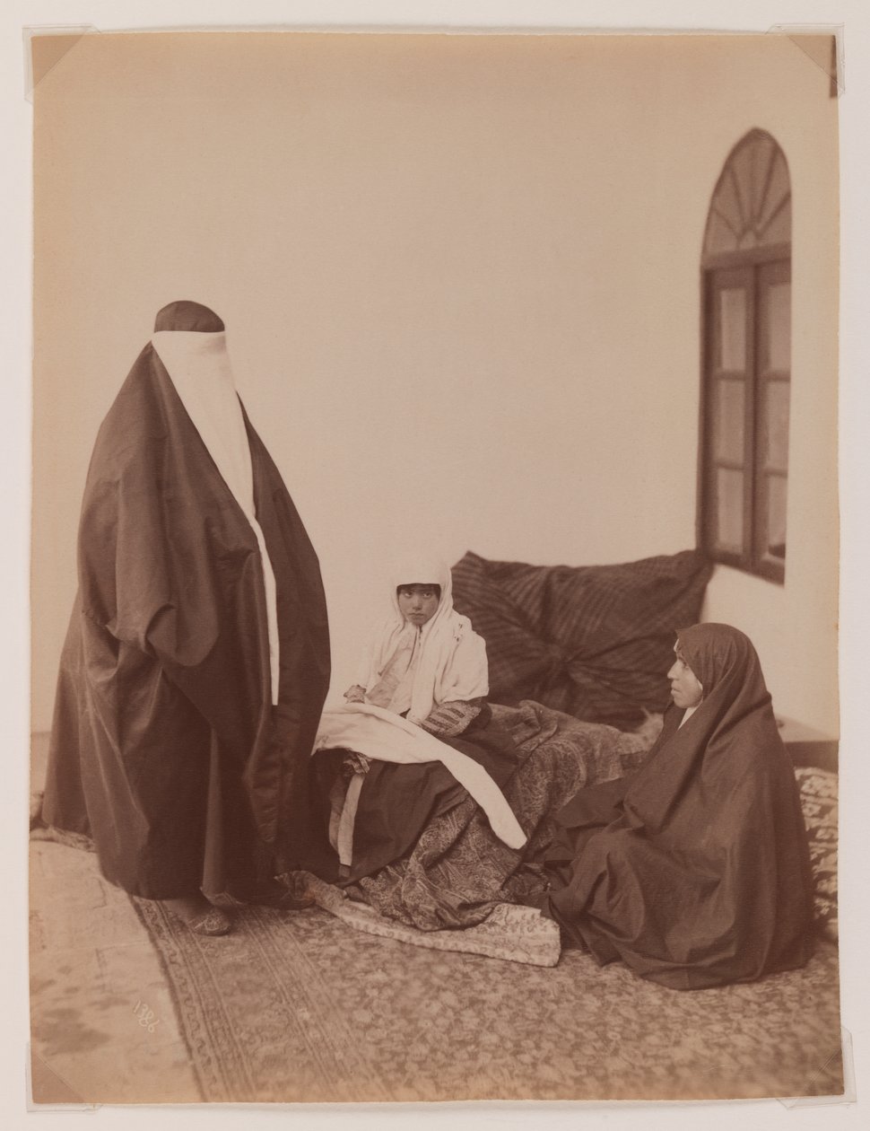 Two veiled women and a child by Antoin Sevruguin