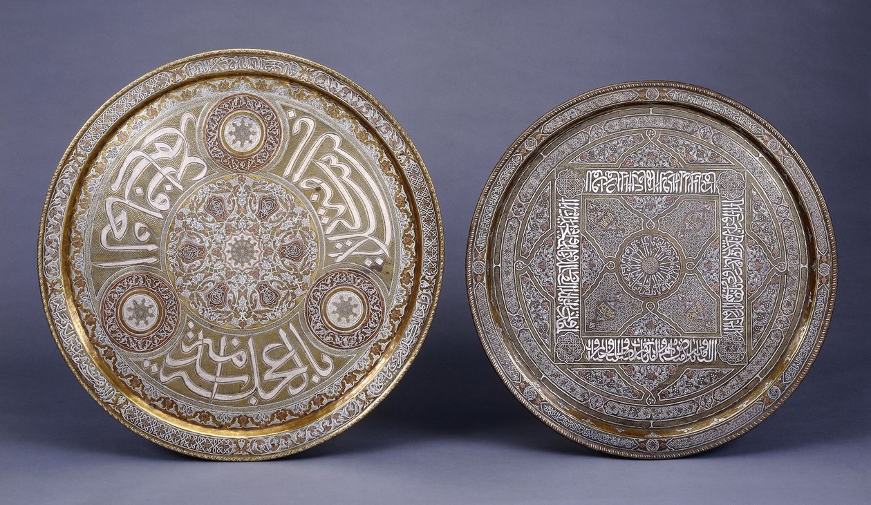 Two gold, copper and silver inlaid brass circular trays, decorated with arabesques and inscriptions, late 19th century by Arabic School