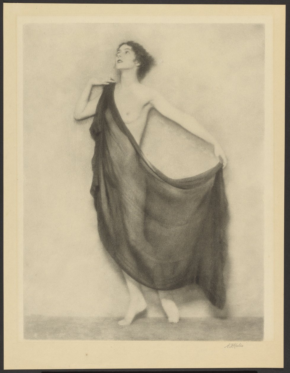 Draped Female Nude Standing Against a Bare Background by Arthur F. Kales