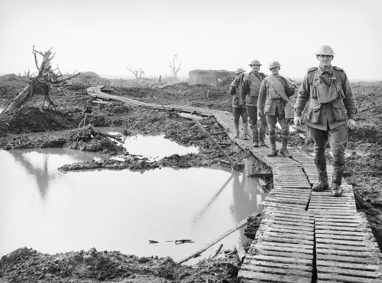 Four Australian soldiers walking along the duckboard track at Tokio, near Zonnebeke, in the Ypres sector, over a portion of the country captured by the Australians in the fighting of the Third Battle by Australian Photographer