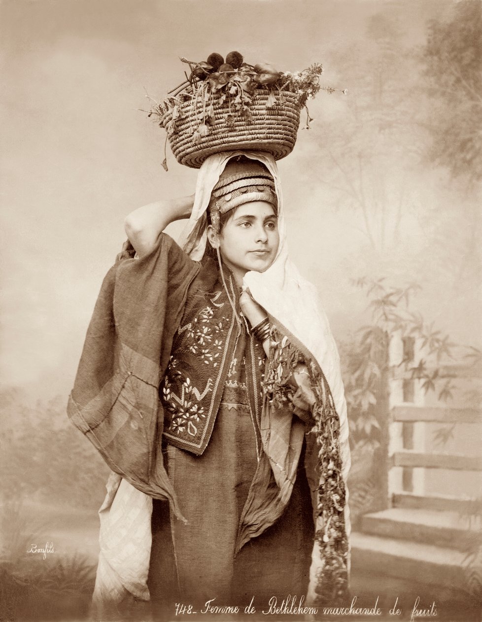 Woman with a basket of fruit on her head, c.1867-98 by Bonfils Studio