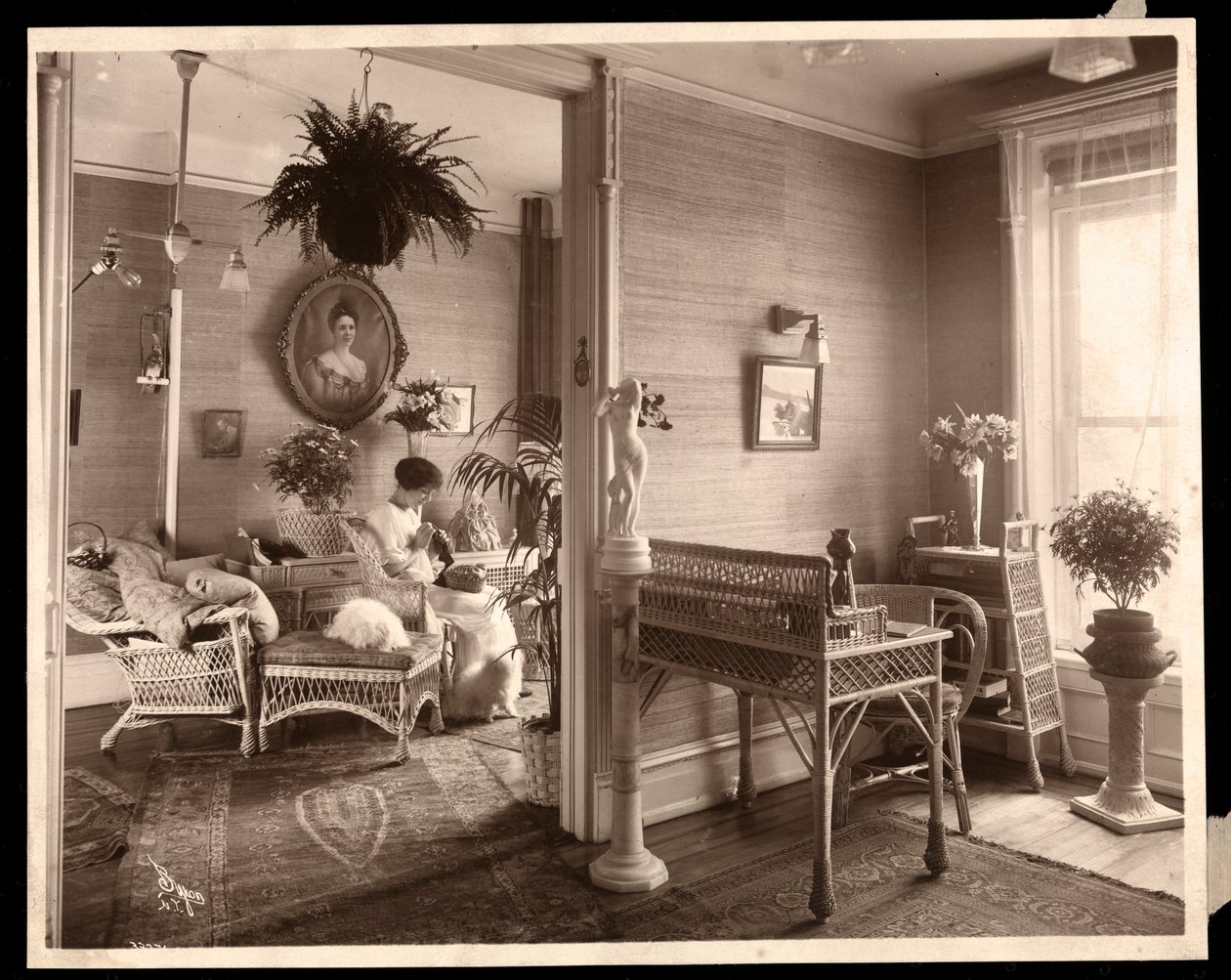 A woman doing needlework in a sitting room, 1914 or 1915 by Byron Company