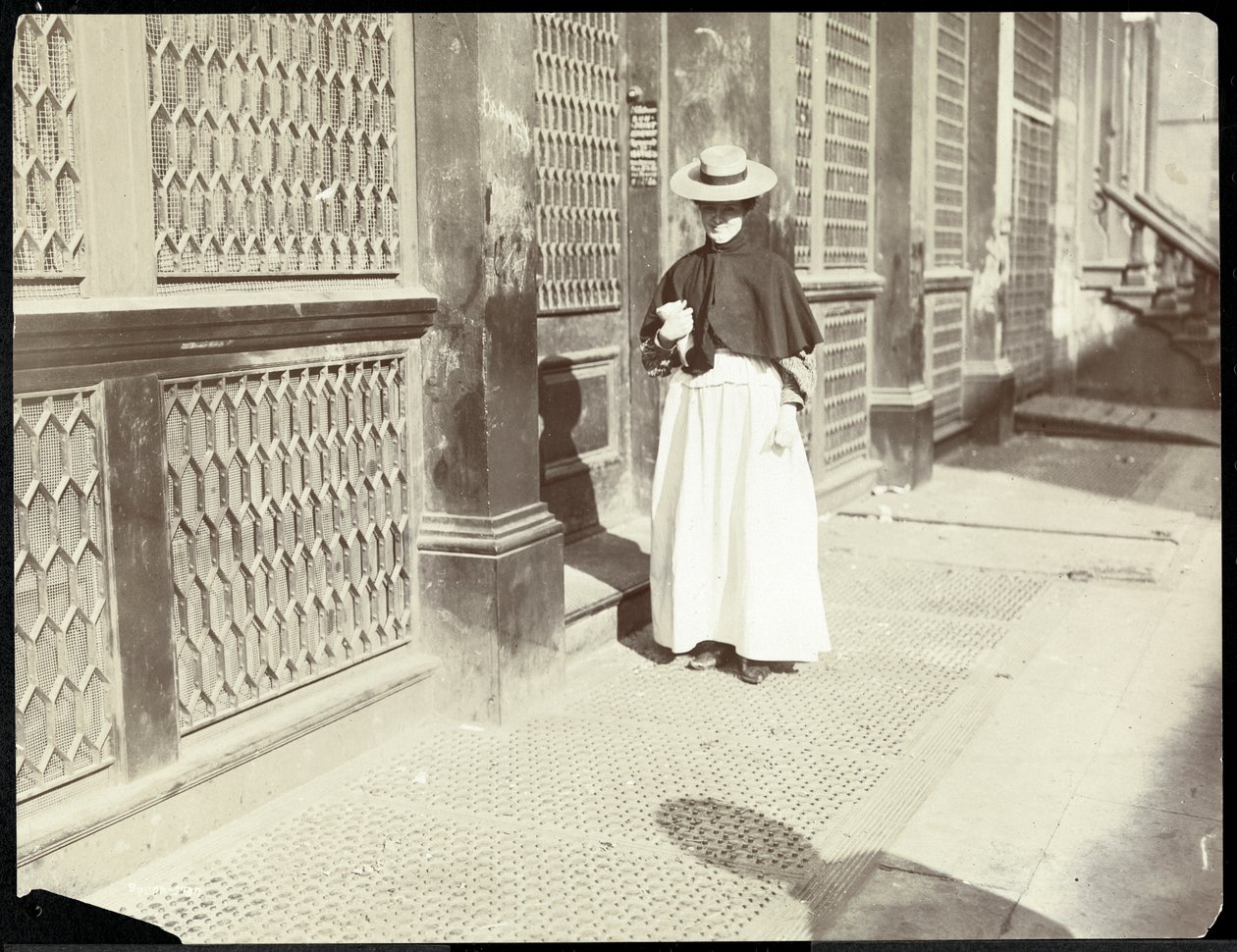 A woman walking down a sidewalk, New York, 1896-98 by Byron Company