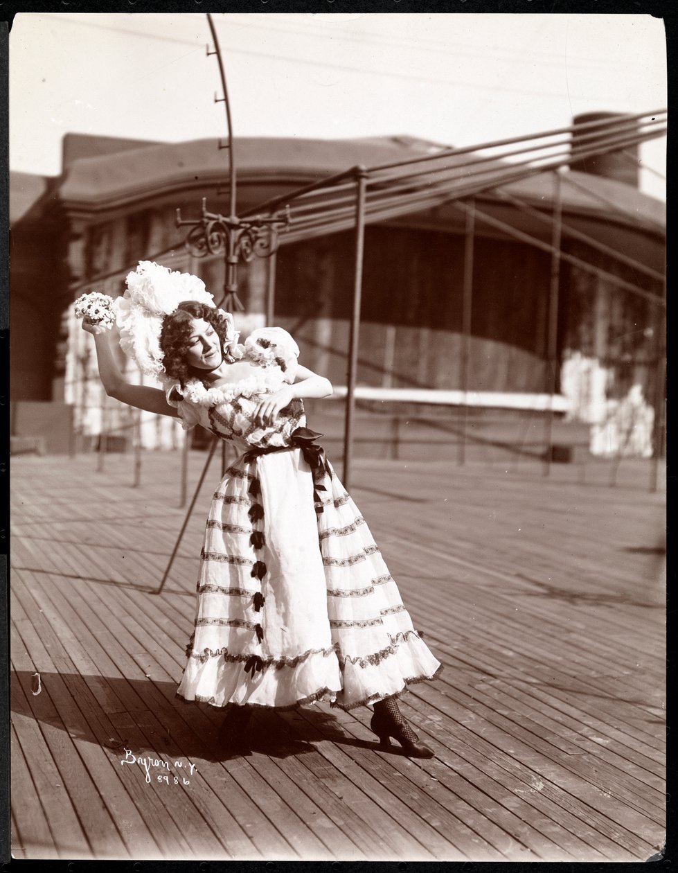 An actress in costume rehearsing on the roof of what is probably the New York Theatre, New York, 1900 by Byron Company