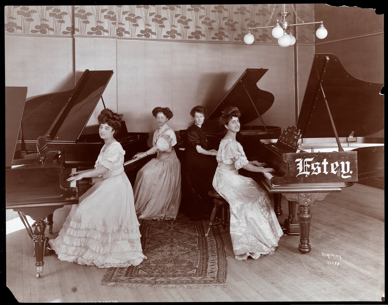 Four Women Seated at Pianos at the Estey Piano Corporation, 1908 by Byron Company