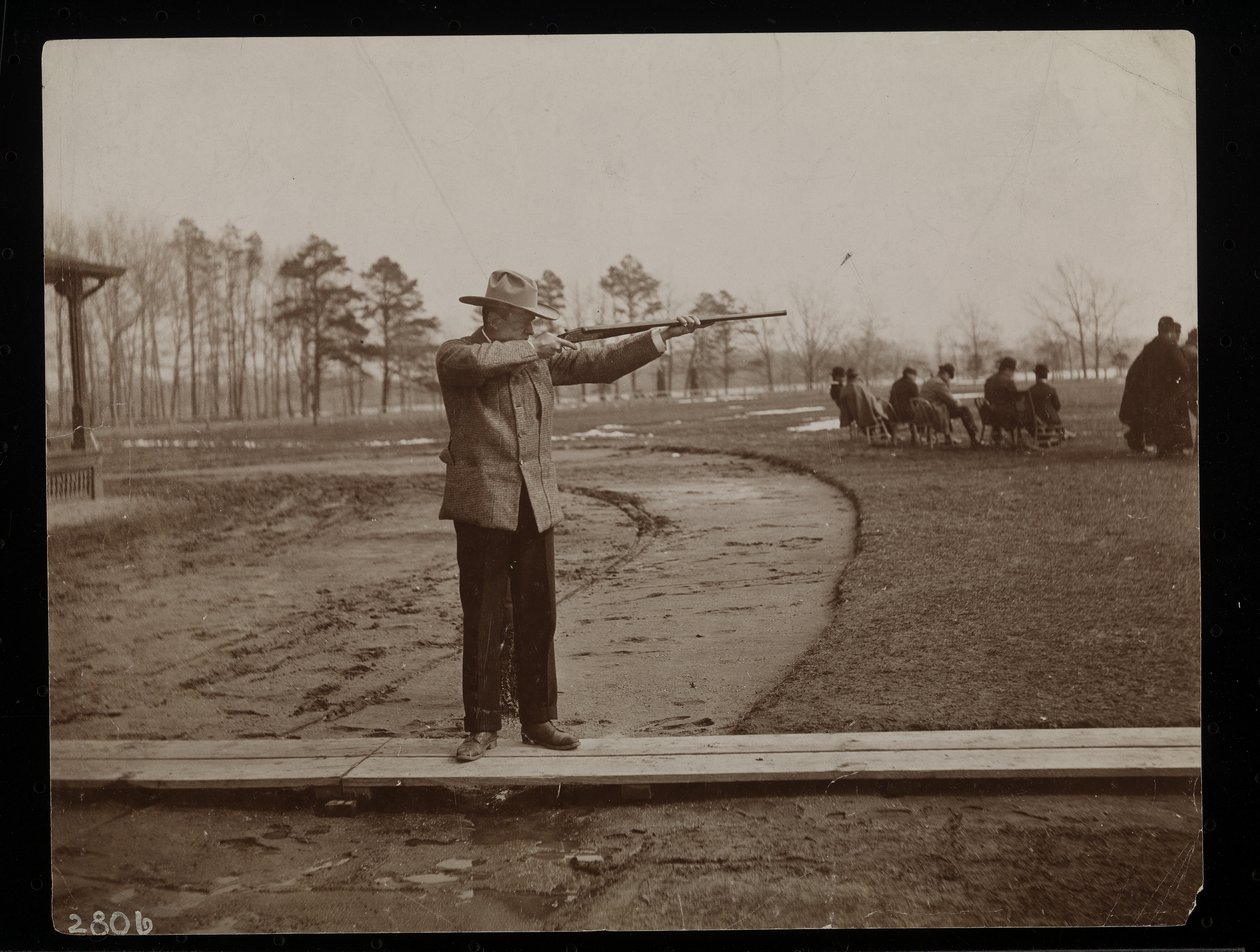 Frank Work Aiming a Rifle at a Trap Shoot, New York, 1896 by Byron Company