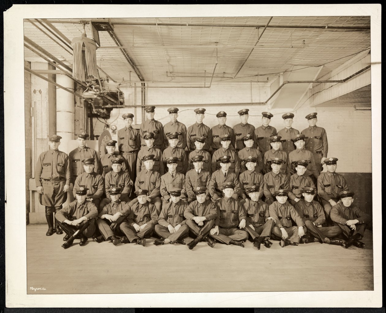 Group portrait of uniformed drivers and delivery men for the Carolyn Laundry at 111 East 128th Street, East Harlem, New York, 1928 by Byron Company