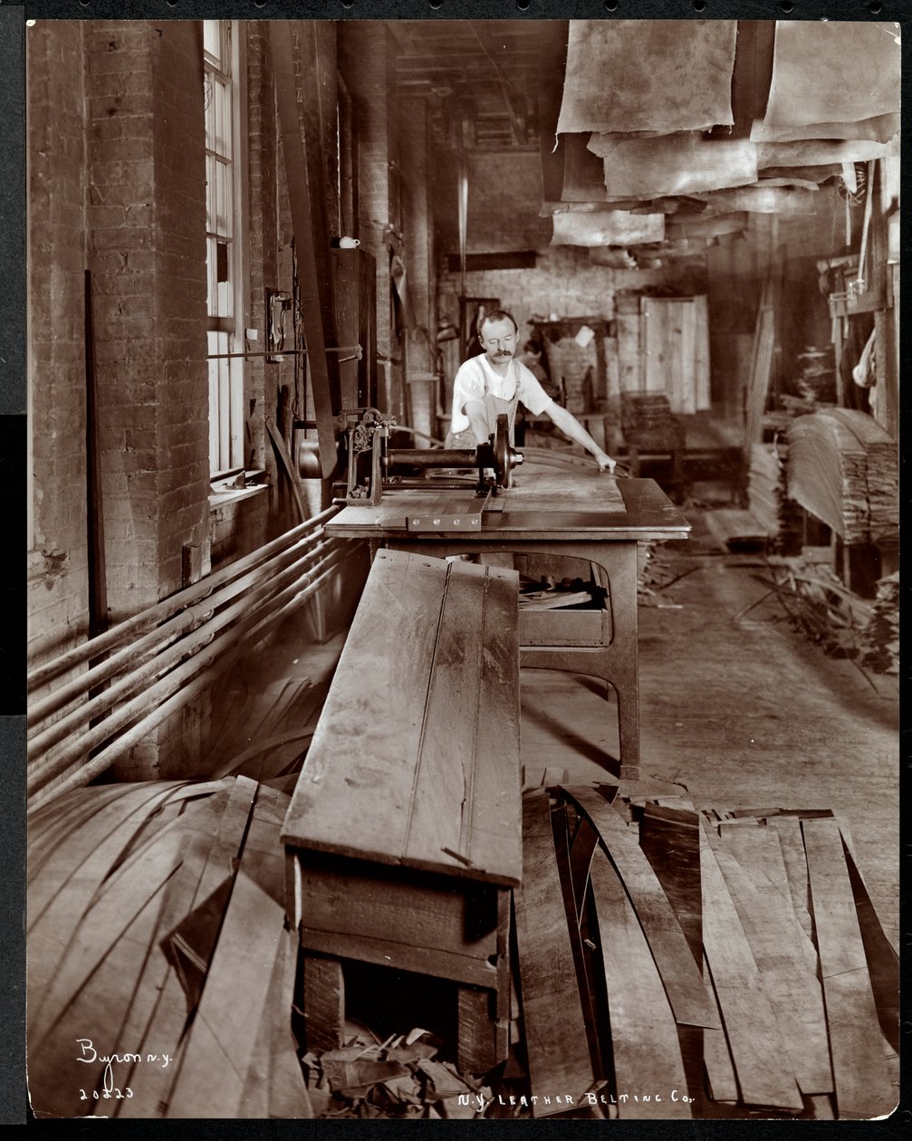 Interior View of a Man Working with Leather at the New York Leather Belting Co., New York by Byron Company