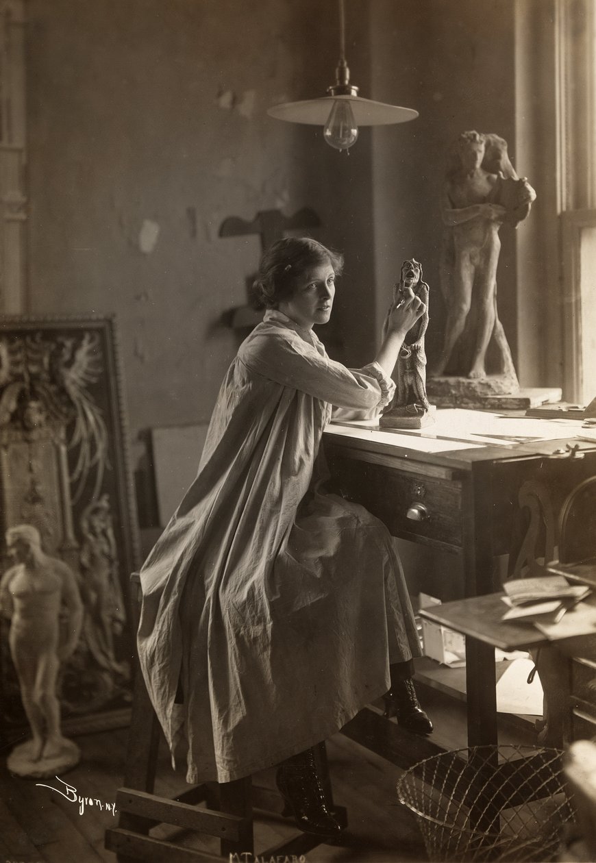 Mabel Taliaferro working on a sculpture in her studio, New York, c.1916 by Byron Company