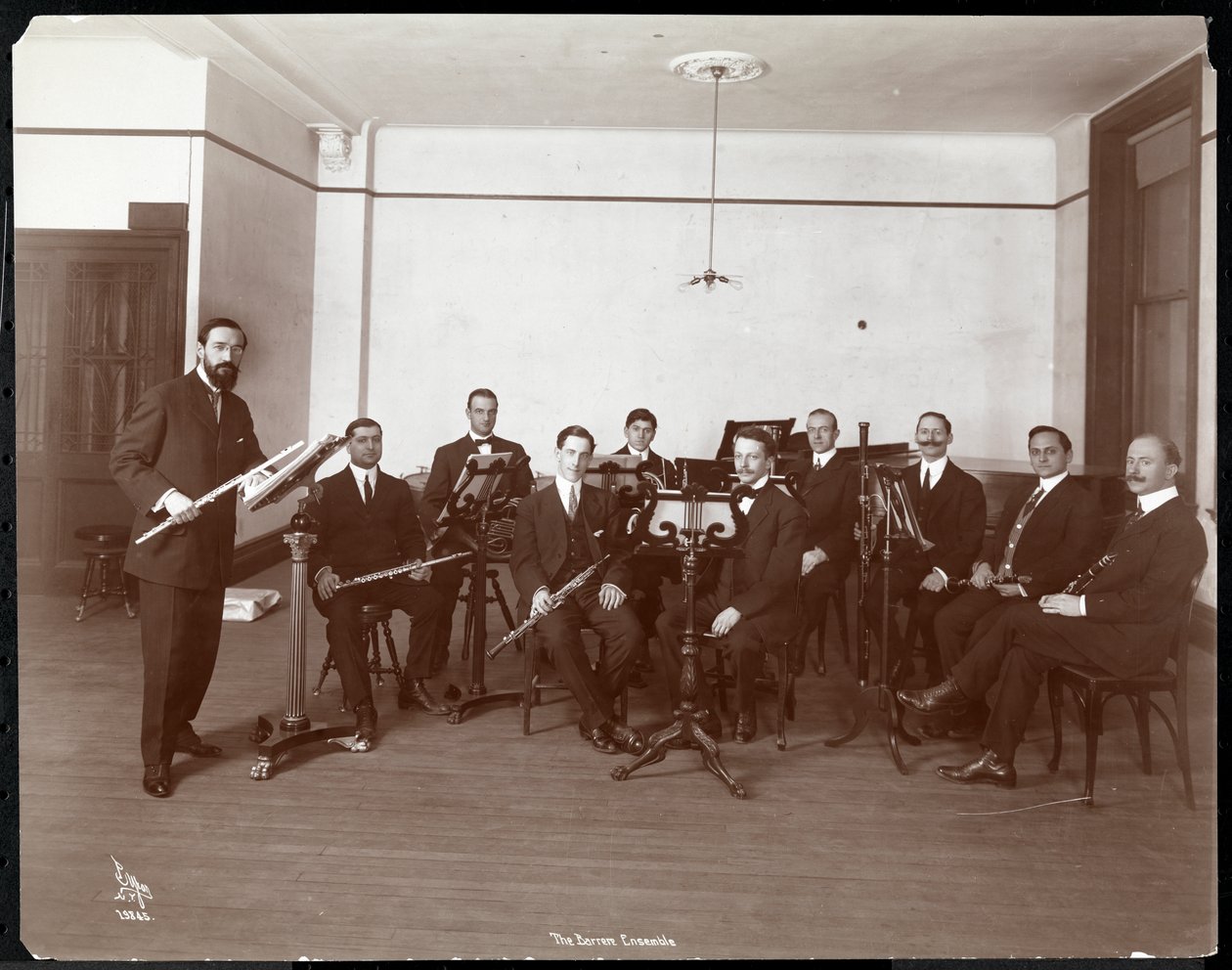 Men from the Barrere Ensemble Orchestra with Wind Instruments by Byron Company