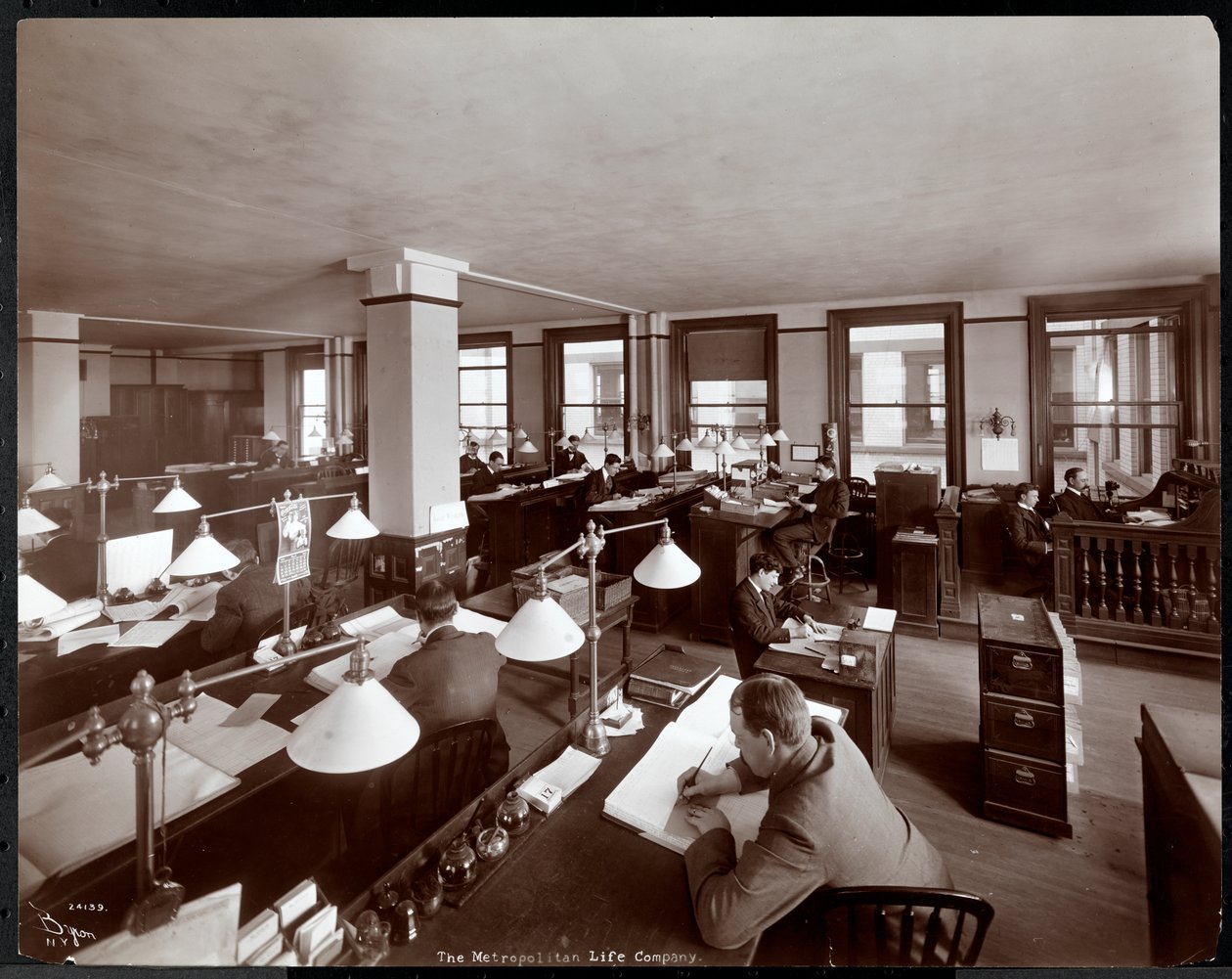 Men working in an office at the Metropolitan Life Insurance Co. at 23rd Street and Madison Avenue, New York by Byron Company