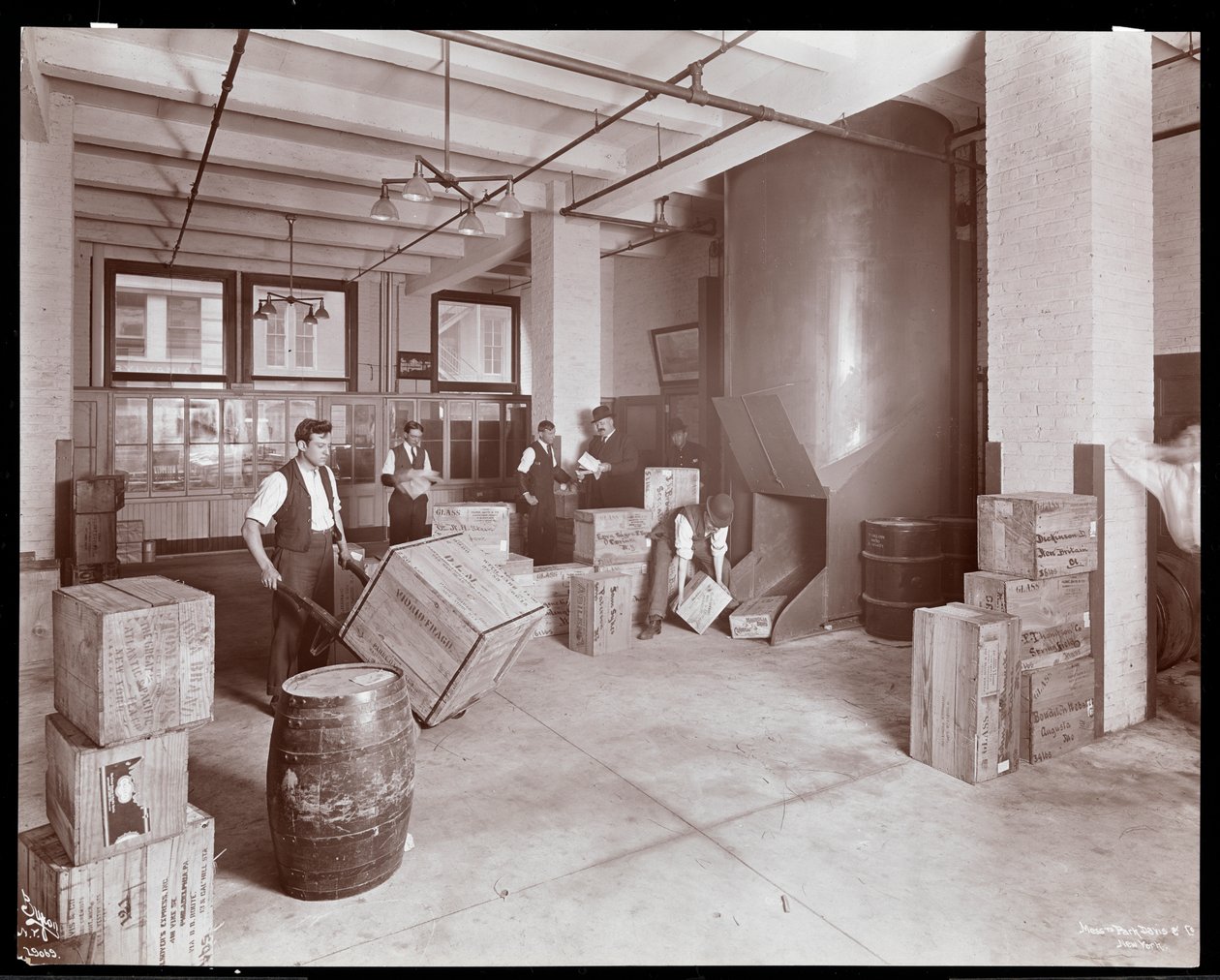 Men working with crates in the shipping department of Parke, Davis und Co., chemists, Hudson und Vestry Streets, New York, 1910 by Byron Company
