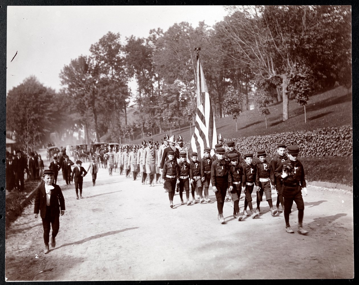 Parade with children and firemen marching in Dobbs Ferry, New York, 1898 by Byron Company