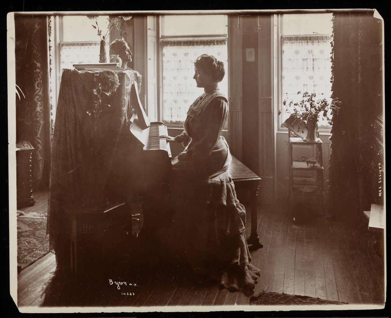 Portrait of Mrs. Elliott or her female relative playing the piano, 1902 by Byron Company