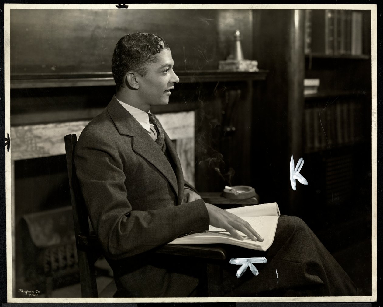 Portrait of blind African American man reading braille at the New York Association for the Blind, 111 East 59th Street, New York, 1935 by Byron Company