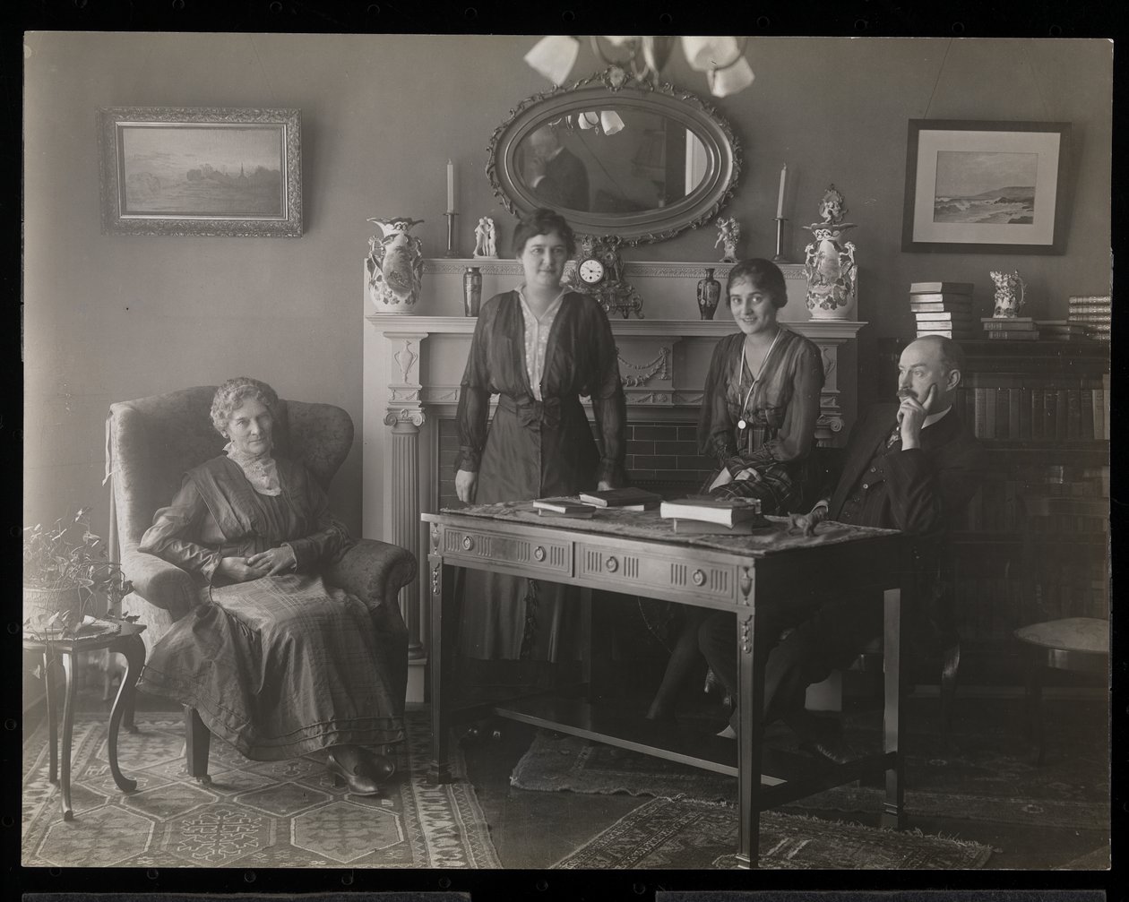 Portrait of the dentist Dr. Gibson and three women in his residence by Byron Company