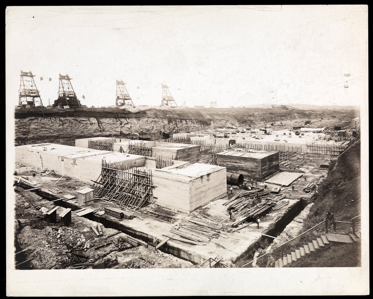 View of construction of the Panama Canal with concrete forms and excavation visible by Byron Company