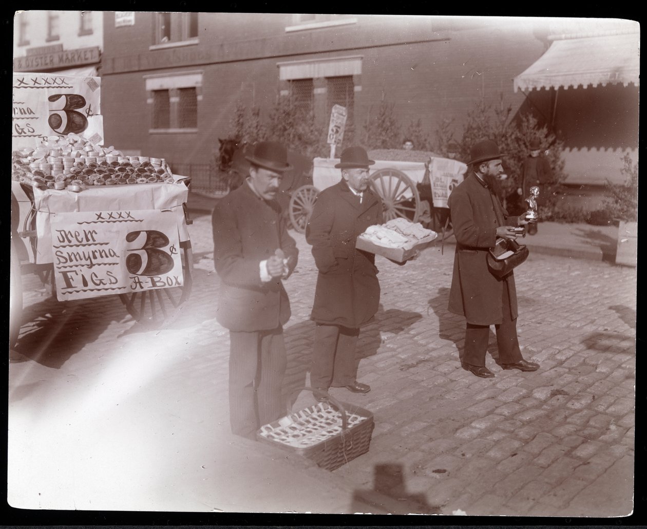 View of street vendors selling figs and other goods near 6th Avenue, New York, c.1903 by Byron Company