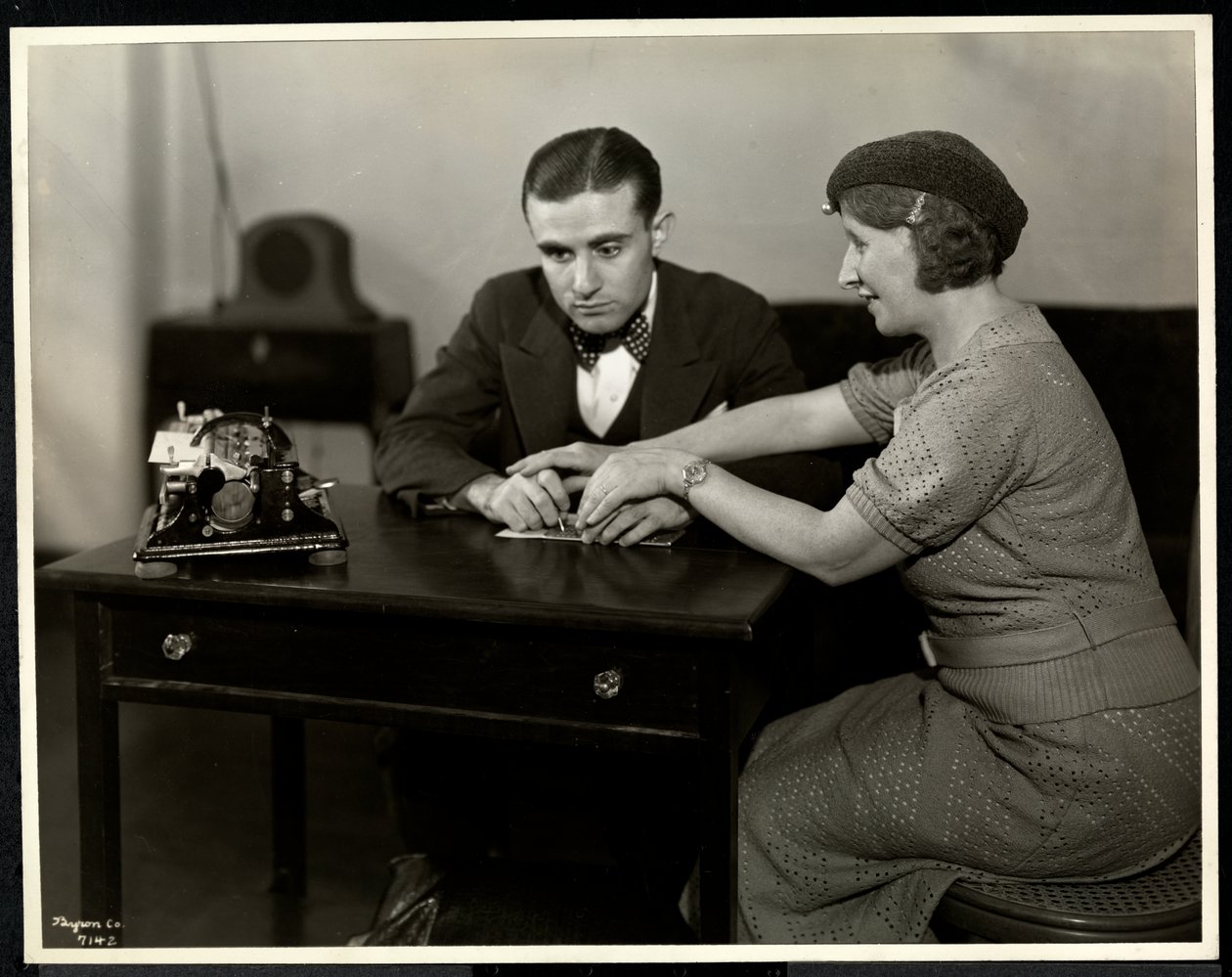 Woman Teaching a Blind Man to Read Braille at the New York Association for the Blind by Byron Company