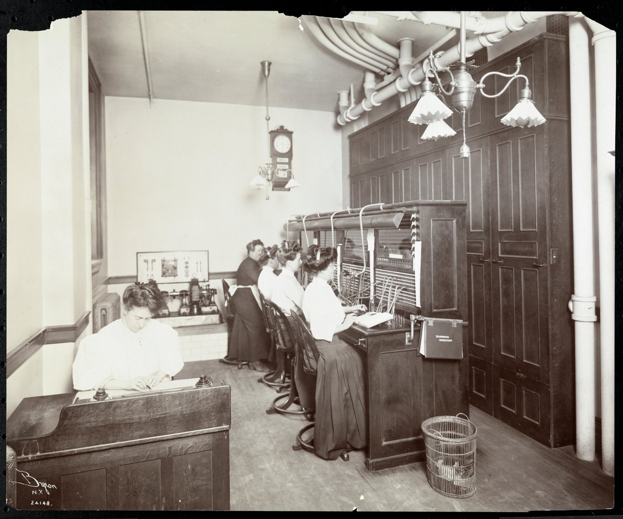 Women working at the switchboard at the Metropolitan Life Insurance Co. at 23rd Street and Madison Avenue, New York, 1907 by Byron Company