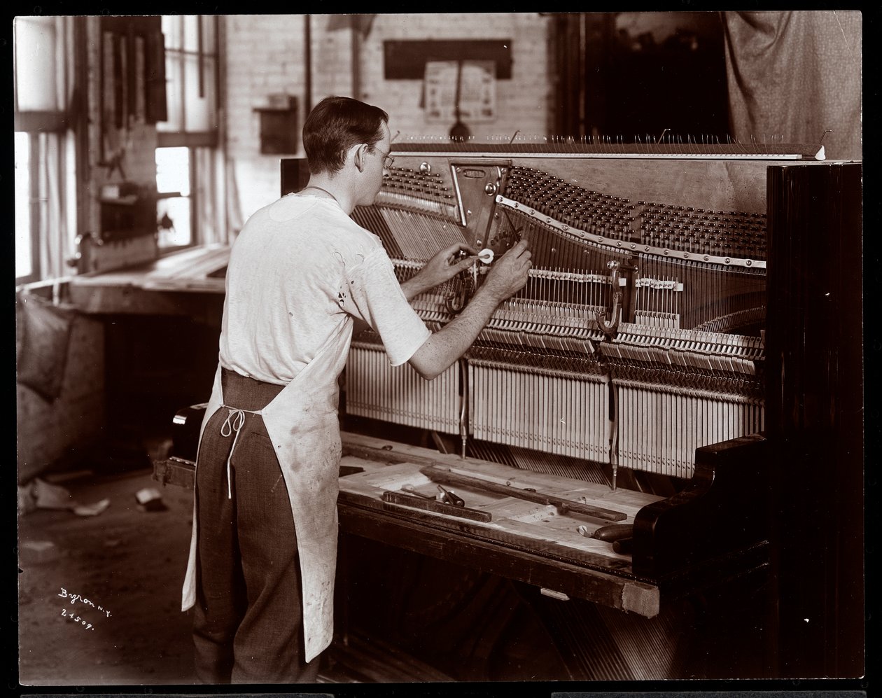 Man Working in the Hardman, Peck and Co. Piano Factory, New York, 1907 by Byron Company
