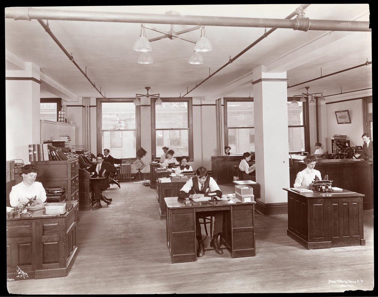 Men and women in an open office at Parke, Davis und Co., chemists, Hudson und Vestry Streets, New York, 1910 by Byron Company