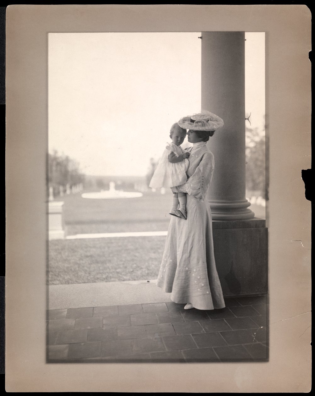 Mrs. Clarence Mackay and child in the portico of Harbor Hill, Long Island 1898-1910 by Byron Company