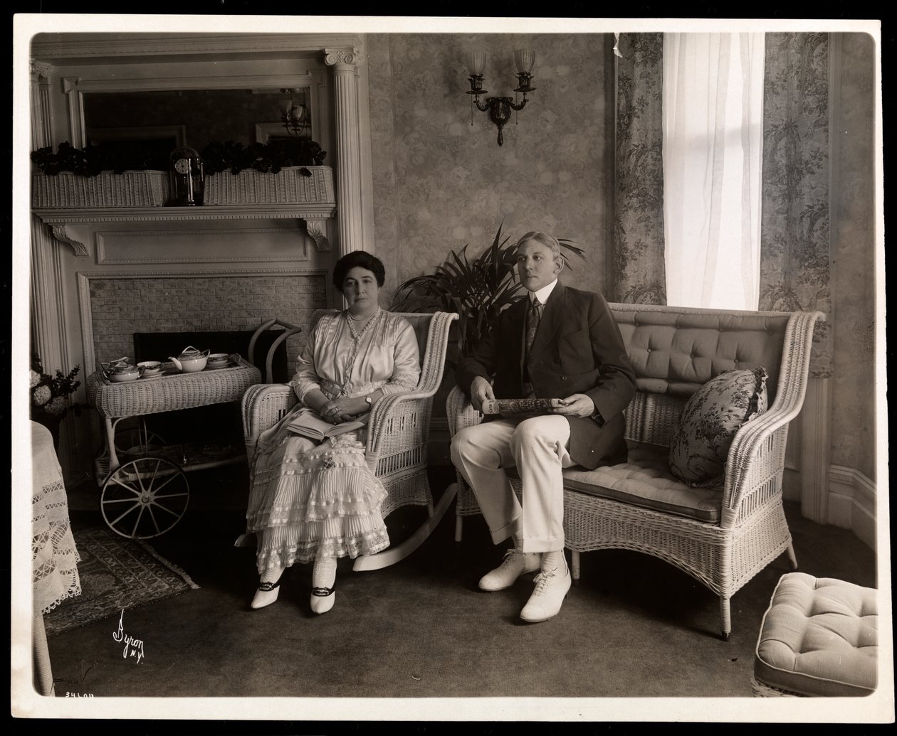 Portrait of Mr. and Mrs. Howard Seated in Their Home at 200 5th Avenue, New York by Byron Company