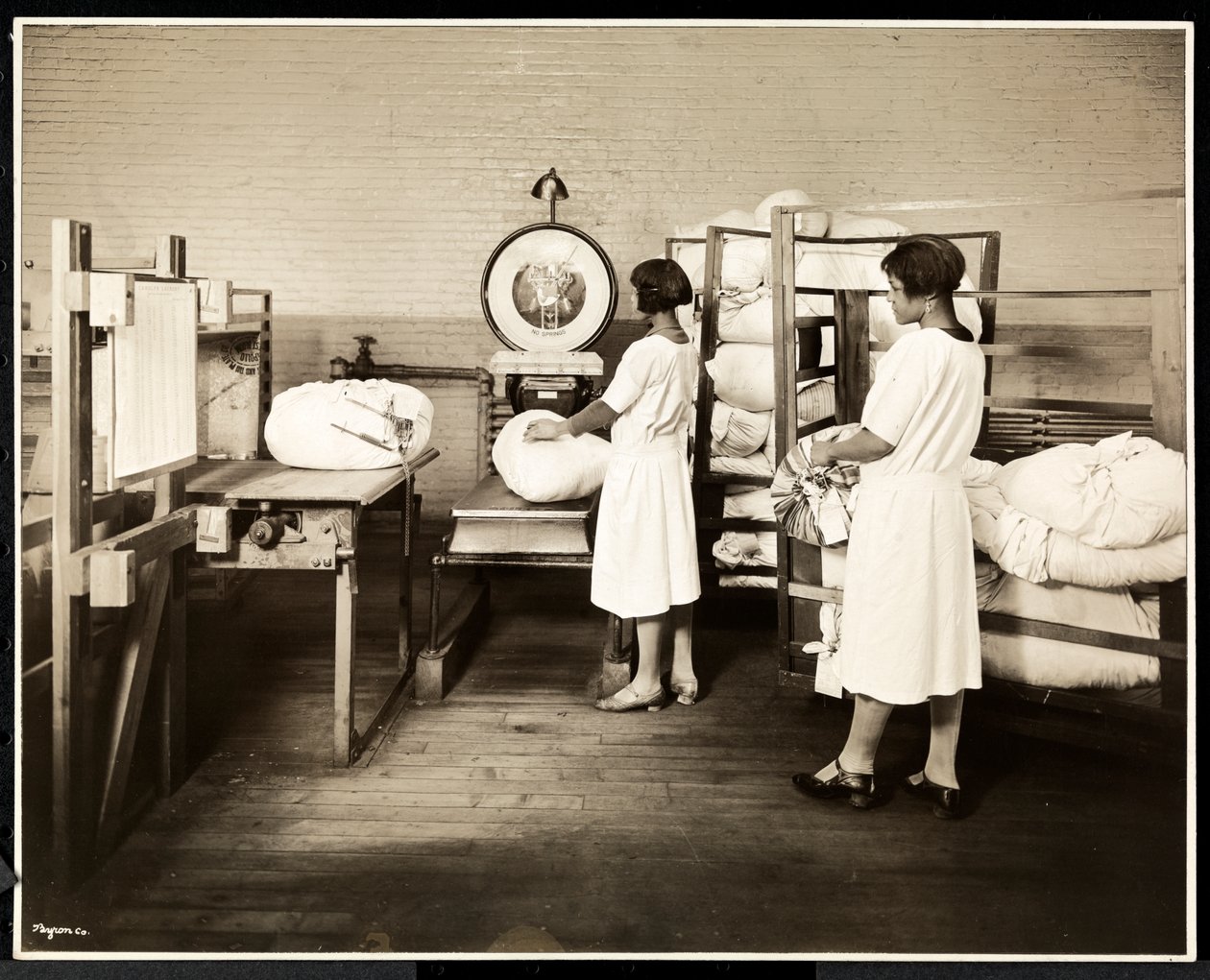 Two African American Women Weighing Bags of Laundry at the Carolyn Laundry, East Harlem, New York, 1928 by Byron Company