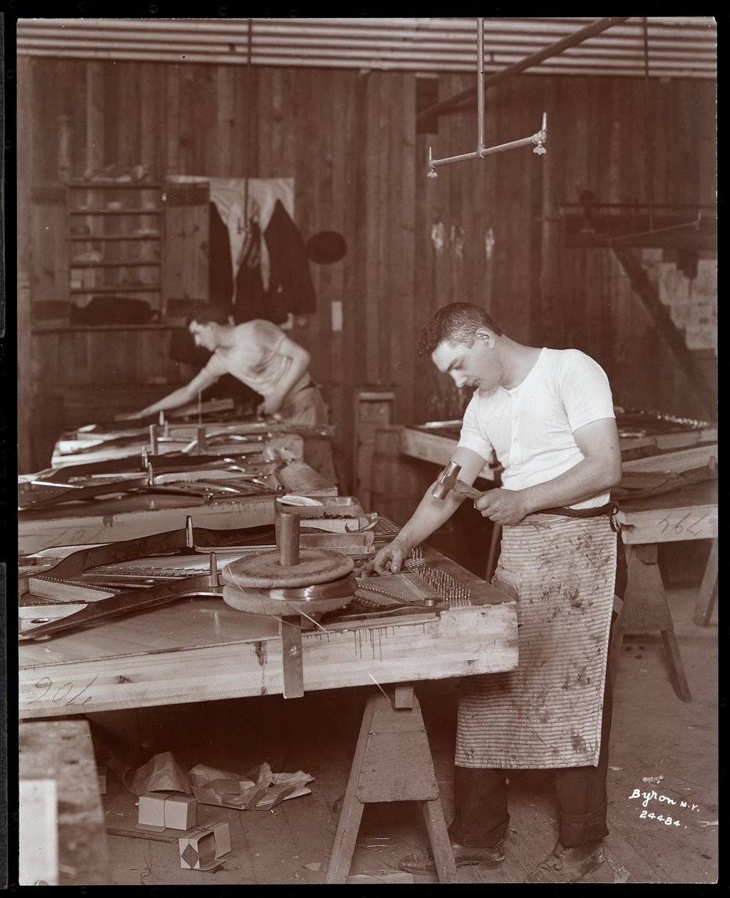 Two Men Working in the Harrington Piano Co. Factory, 1907 by Byron Company